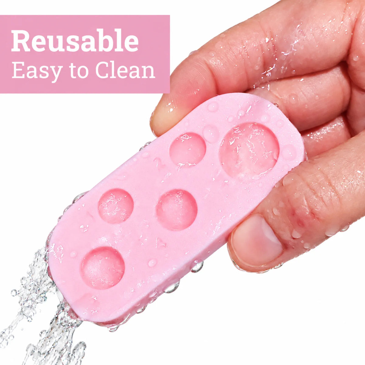 Lomansa reusable pink lash lift lotion palette with five wells being rinsed under running water for easy cleaning.