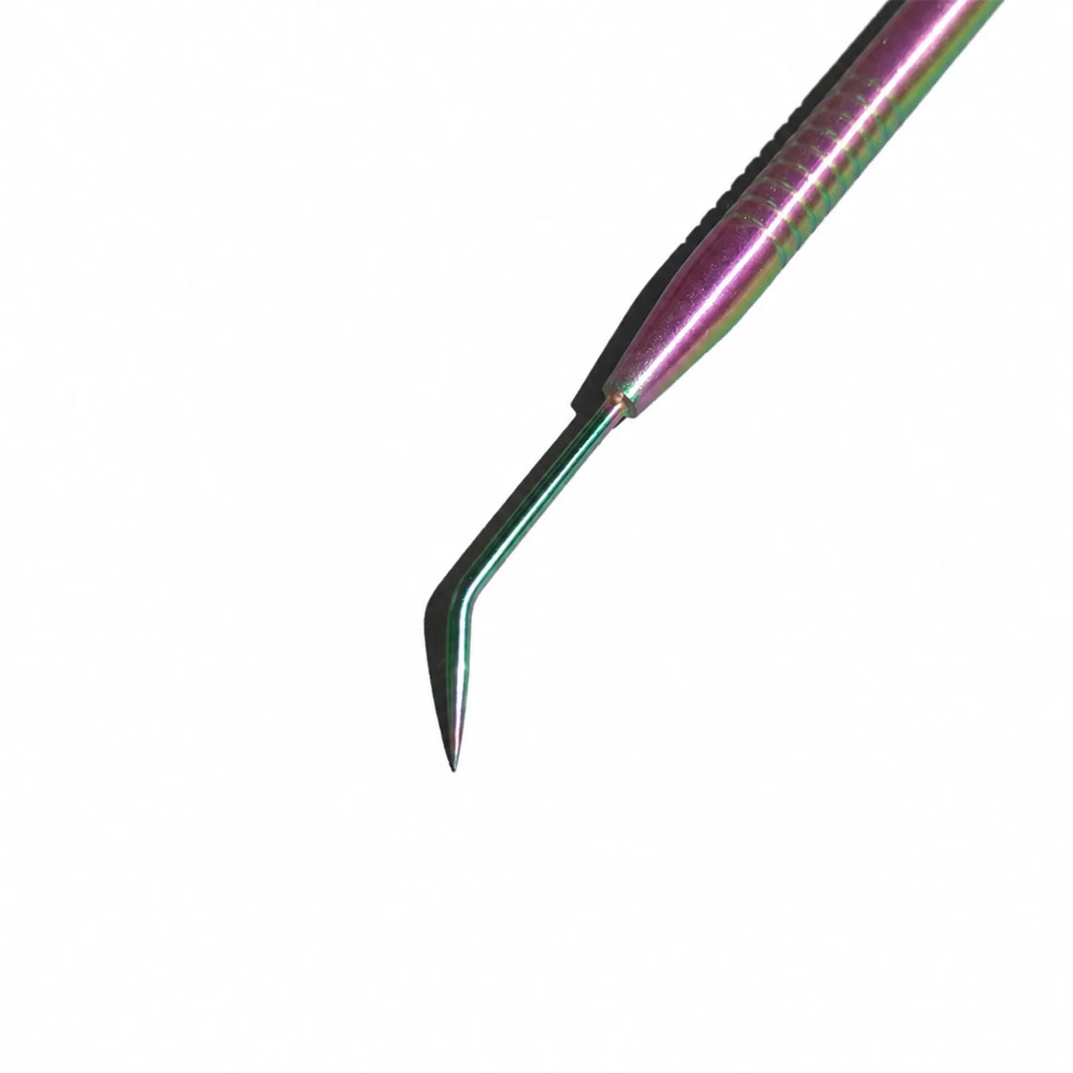 Lomansa rainbow dual-ended lash lift separator close-up showing its bent pointed metal hook on a gray textured surface.