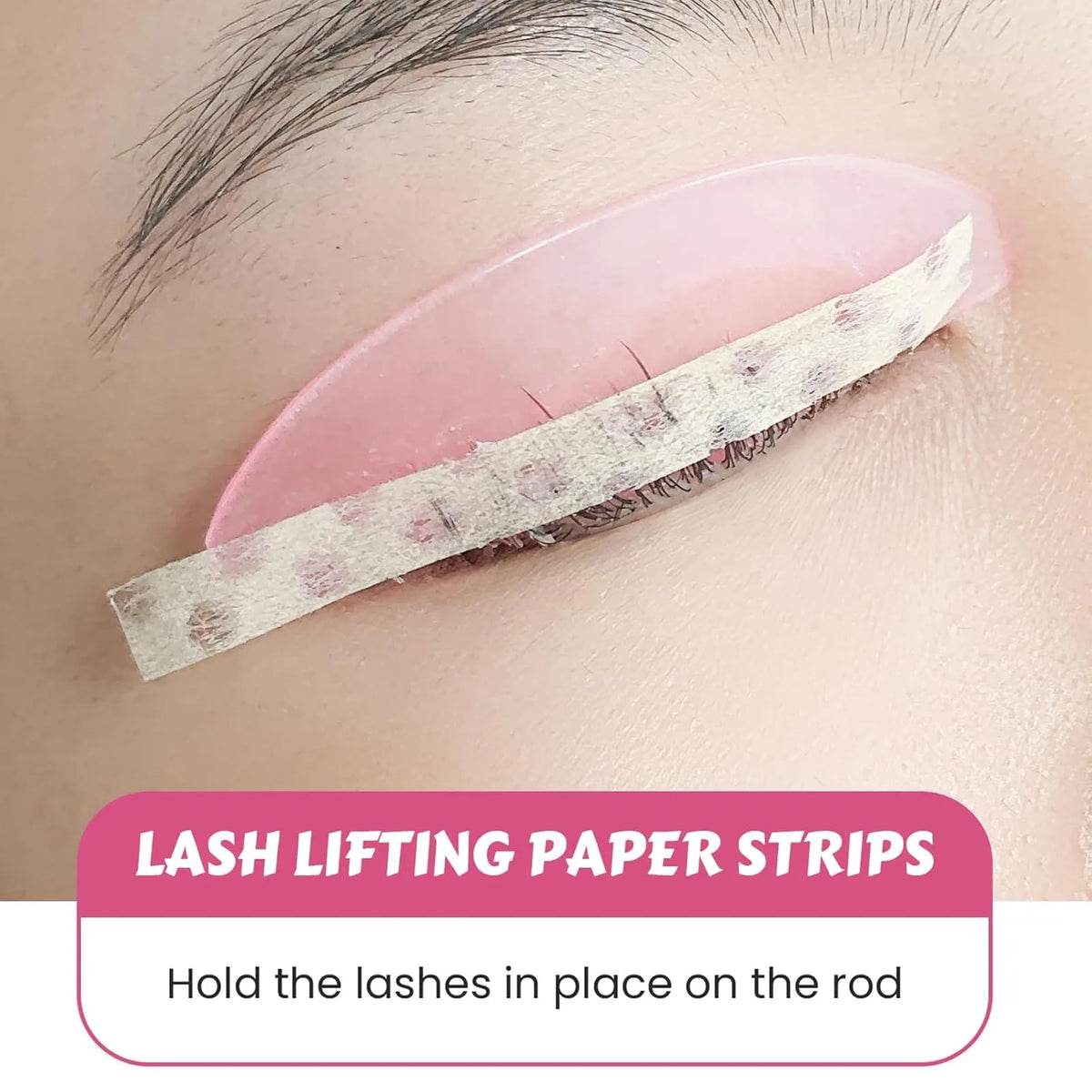 Lomansa lash lift paper strips holding eyelashes against a pink silicone shield during a lash lift treatment.