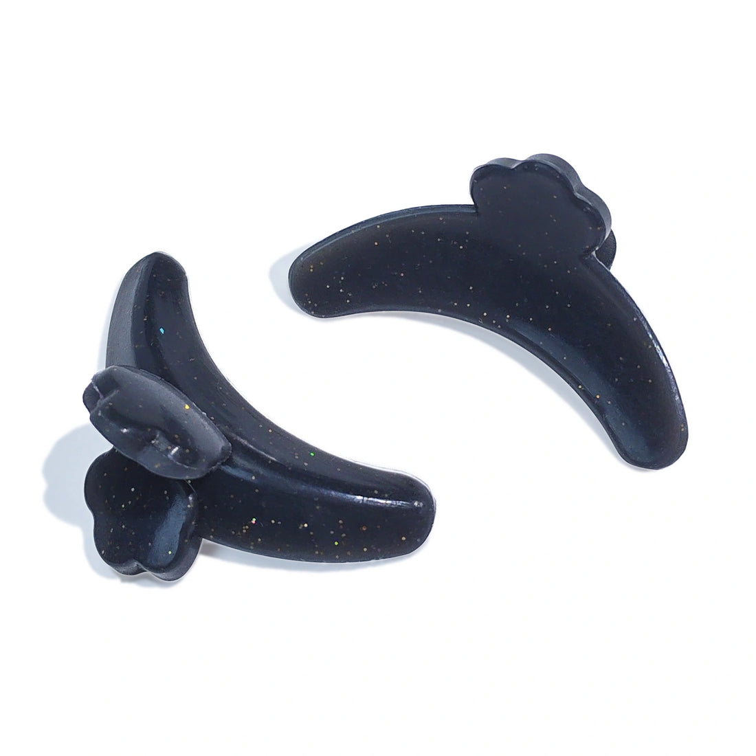 Black curved eyelash shields with glitter flecks, shown from the front and back on a white background.