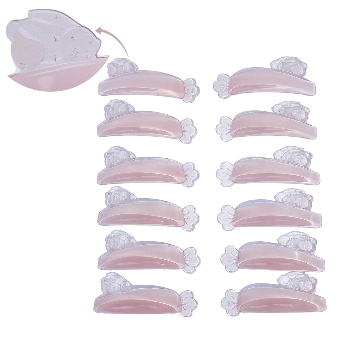 LOMANSA translucent pink Korean lash lift silicone shields with curved pads and flower-shaped ends arranged in two rows.