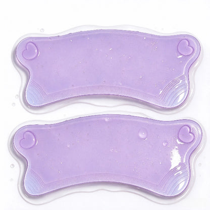 Close-up of two LOMANSA purple lash lift pads with heart-shaped details and curved textured edges.