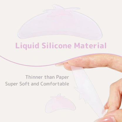 LOMANSA liquid silicone lash lift shield shown bending between fingers to demonstrate its thin, flexible texture.