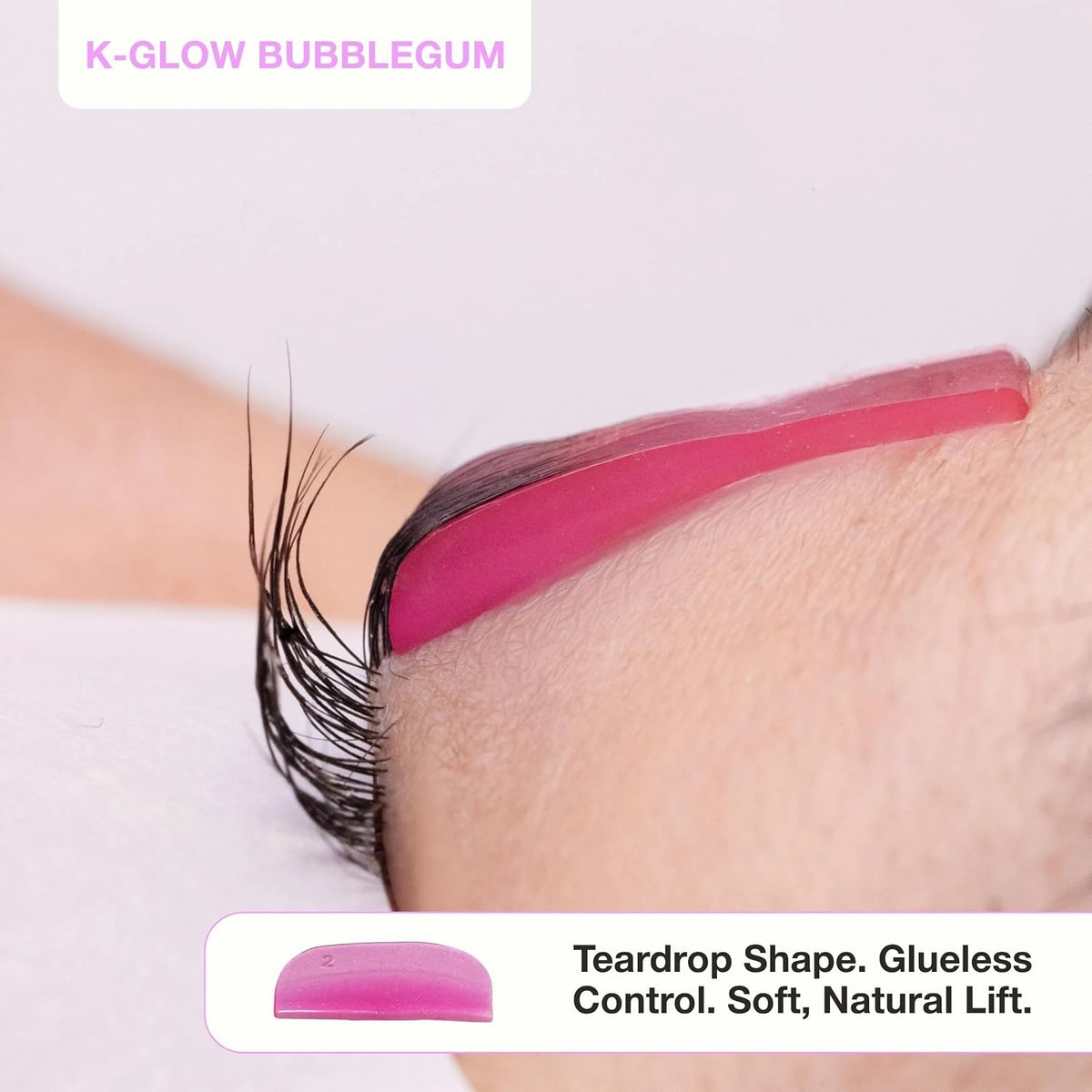 Side view of pink K-Glow Bubblegum silicone lash lift shield showing its teardrop shape and lifted eyelashes.