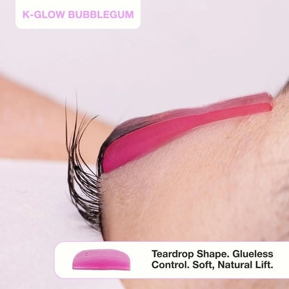 Side view of pink K-Glow Bubblegum silicone lash lift shield showing its teardrop shape and lifted eyelashes.