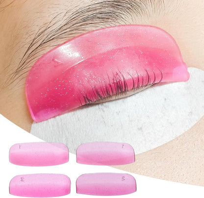 Pink LOMANSA silicone lash lift shield on an eyelid with lashes aligned over the pad, plus four numbered shields.