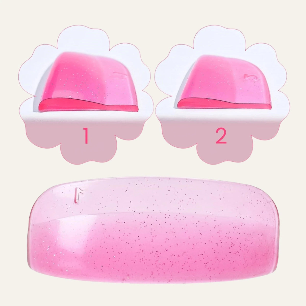 Close-up of pink glitter silicone lash lift shields showing curved profiles and numbered size 1 and 2 options.