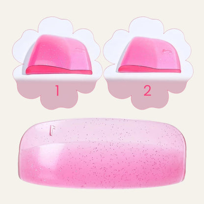 Close-up of pink glitter silicone lash lift shields showing curved profiles and numbered size 1 and 2 options.