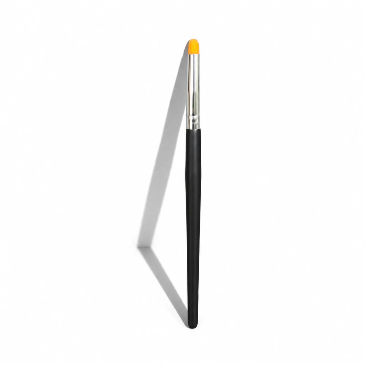 Lomansa lash lift applicator brush with a black handle, silver ferrule and short orange rounded bristles.
