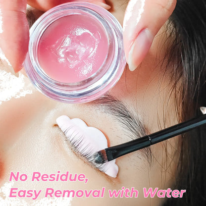 Professional lash lift application with an open LOMANSA balm jar and lashes brushed onto a silicone shield