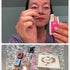 Woman holding a Lomansa Step 1 lash lift sachet and applicator above the kit contents and tools.